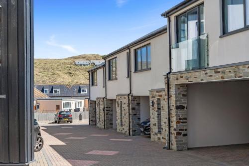 a row of buildings with their doors open on a street at 5 The Dunes in Perranporth