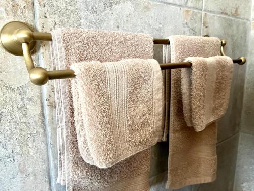two towels hanging on a towel rack in a bathroom at MILIMA Big 5 Safari Lodge in Hoedspruit