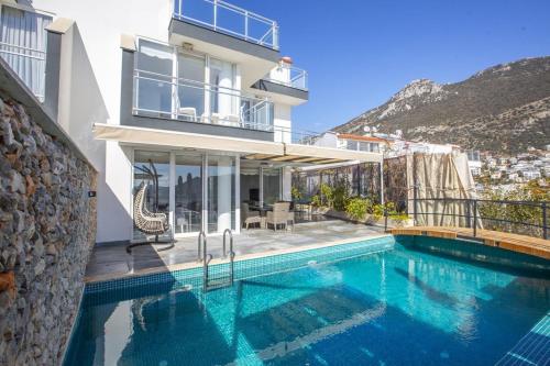 a villa with a swimming pool and a house at Villa Royal 1 in Kalkan