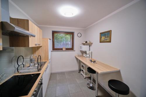 a kitchen with a counter and a sink and a counter top at Apartament Przy Beczce in Kowary