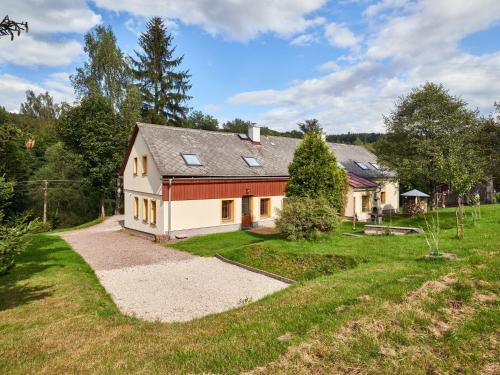 a house with a driveway and a grass yard at Holiday Home in Lampertice with Swimming Pool in Lampertice