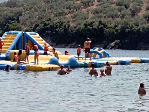 a group of people are in the water on an inflatable raft at Theoxenia in Pteleós