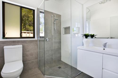 a bathroom with a toilet and a sink at Villa Mare I 4 Mins to Beach in Culburra Beach