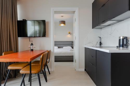 a kitchen and dining room with a table and chairs at The SPOT apartments - Orbi Beach Tower in Batumi