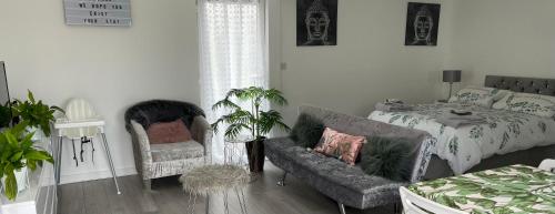 a bedroom with a bed and a couch and a chair at Nicolas Devon air bed and breakfast in Ilfracombe