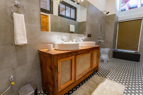a bathroom with a sink and a toilet at Seclude Shimla, Taraview in Shimla