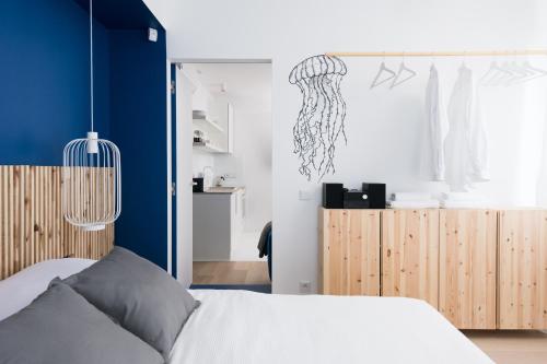 a bedroom with a bed and a dresser at Colors Apartments in Zator