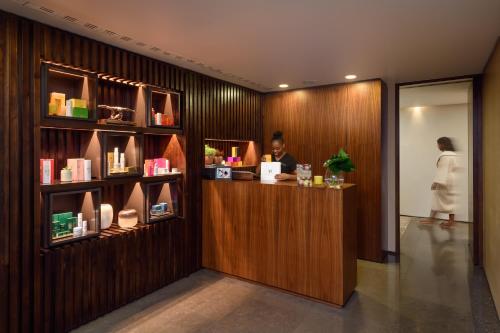 a woman standing at a counter in a salon at Inspira Liberdade Boutique Hotel in Lisbon