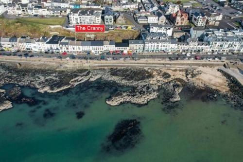 an aerial view of a city and the ocean at The Cranny, Portstewart in Portstewart