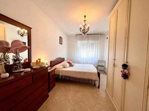 a bedroom with a bed and a dresser with a mirror at Le Chiazze in Spotorno