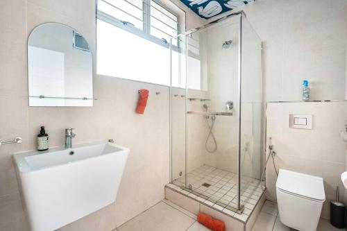 a bathroom with a shower and a sink and a toilet at 1002 La Ballito-trendy apartment with endless view in Ballito