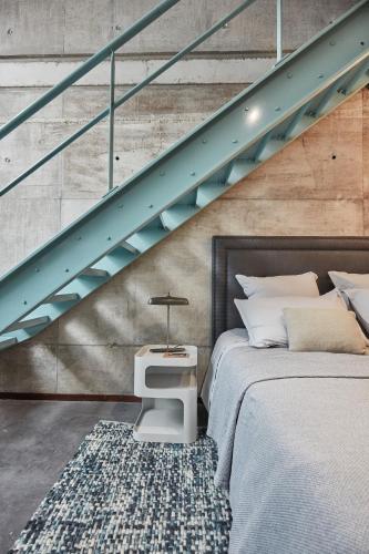 a bedroom with two beds and a staircase at LA PORTE ROUGE RBX in Roubaix