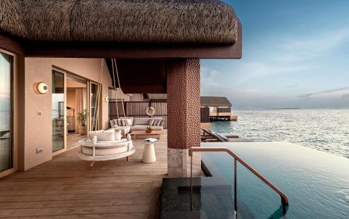 a villa with a swimming pool on the water at JOALI BEING in Raa Atoll
