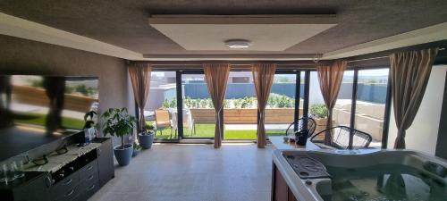 a large kitchen with a view of a patio at Jacuzzi Home in Oradea