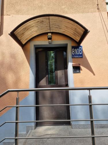 a door to a building with a clock on it at Apartament Lawendowy Gdańsk in Gdańsk