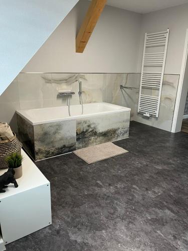 a bathroom with a white tub and a sink at Loft am See in Dargun