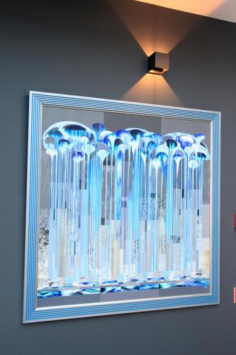 a framed picture of blue glass vases on a wall at Villa Lettonia in Jūrmala