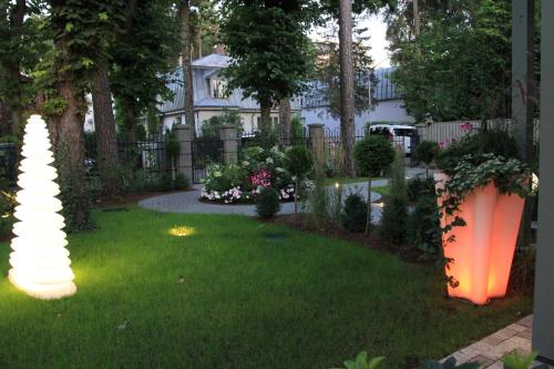 a yard with some lights in the grass at Villa Lettonia in Jūrmala