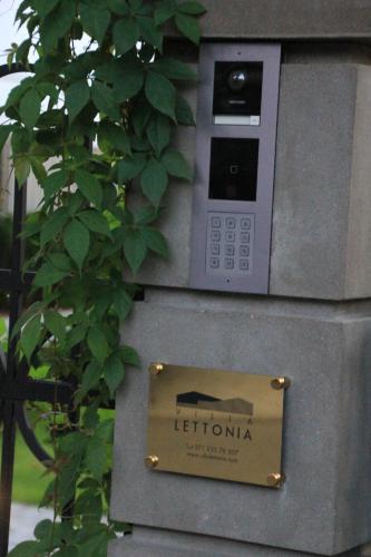 a parking meter with a sign in front of a tree at Villa Lettonia in Jūrmala