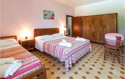 a hotel room with two beds and a chair at Almachiara in Sessa Cilento