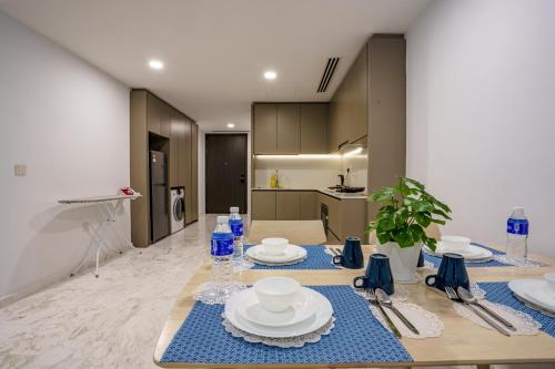 a table with plates and dishes on it in a kitchen at Eaton Residence KLCC in Kuala Lumpur