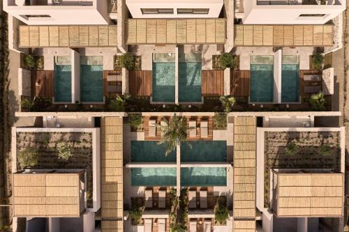 een uitzicht op een gebouw met een zwembad bij Theros All Suite Hotel - Adults Only in Kos-stad