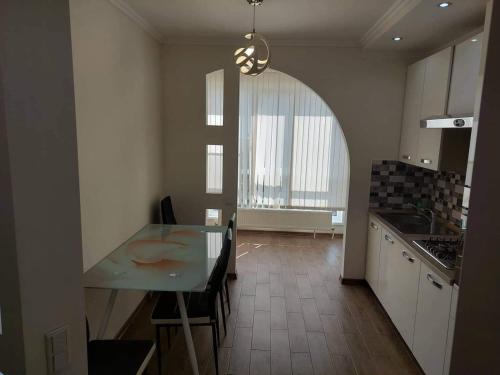 a kitchen with a table and a dining room at English Breakfast in Chişinău