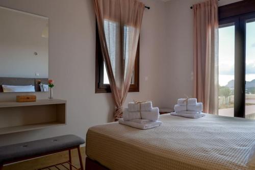 a bedroom with a bed with two pillows on it at Casa Avgerinou in Afantou