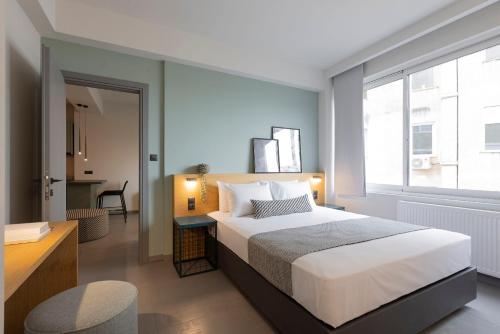 a bedroom with a bed and a desk and a window at K4 0 City Apartments, Historical Center, Thessaloniki #FeelsLikeHome in Thessaloniki