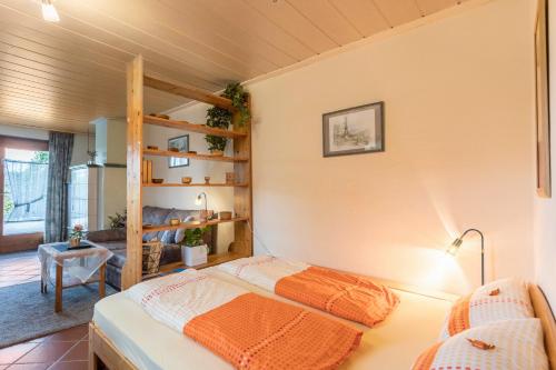 a bedroom with a bunk bed and a living room at Haus Rosi und Werner in Emmerting