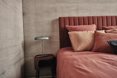 a bedroom with a bed and a lamp on a table at LA PORTE ROUGE RBX in Roubaix