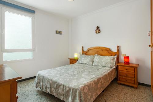 a bedroom with a bed and a window at Casa Luis Montesdeoca in Puerto de Mogán