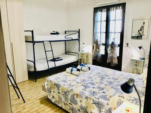 um quarto com uma cama e 2 beliches em Villa Ro em Porto Columbu - Perdʼe Sali
