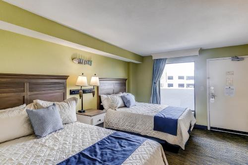 a hotel room with two beds and a window at Caribbean Resort 525 in Myrtle Beach