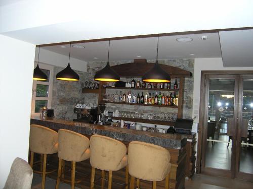 
a dining room with a bar and a large window at Livadia Hotel Kyperounta in Kyperounda
