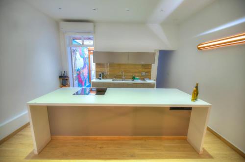 a kitchen with a large white island in a room at Eco-friendly & spacious 1bedroom townhouse PCUT1-1 in Il-Gżira