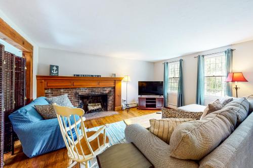 a living room with a couch and a fireplace at Dream Dennis Getaway in Dennis
