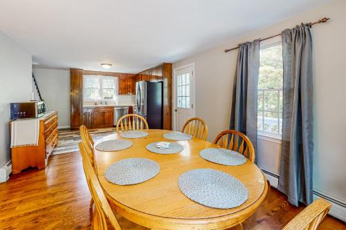a dining room with a wooden table and chairs at Dream Dennis Getaway in Dennis