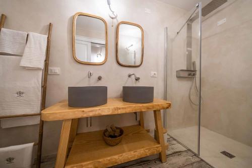 a bathroom with two sinks and a shower at Corte Janca in Montesano Salentino