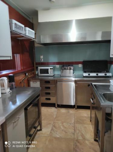 a kitchen with a sink and a stove top oven at Villa Koulouridi Agritourism in Daratso