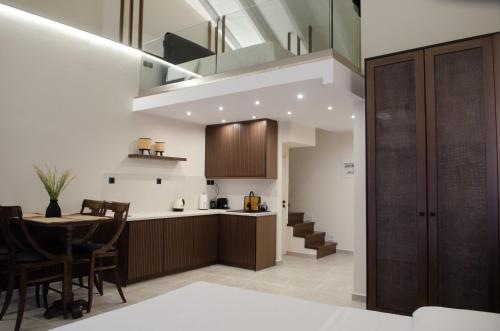 a kitchen and dining room with a table and a staircase at Leone suites in Nafpaktos