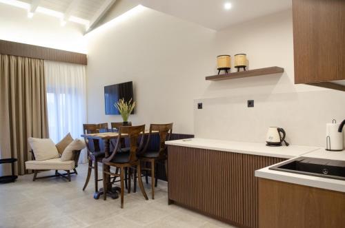 a kitchen and dining room with a table and chairs at Leone suites in Nafpaktos