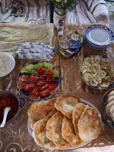 a table topped with plates of food and bowls of fruit at Guest House Stevovski in Ohrid