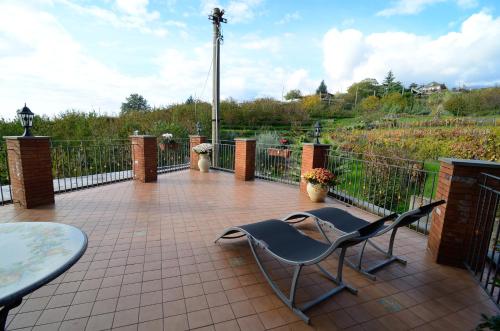 a patio with a table and chairs and a fence at B&B Dimora dell' Etna in Milo