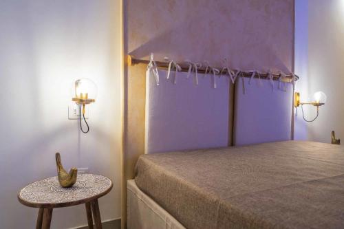 a bedroom with a bed and a table with a banana on it at Corte Janca in Montesano Salentino