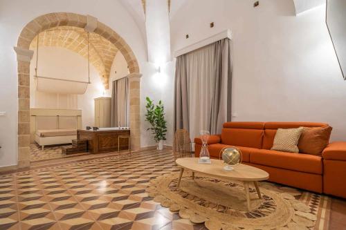 a living room with a couch and a table at Corte Janca in Montesano Salentino