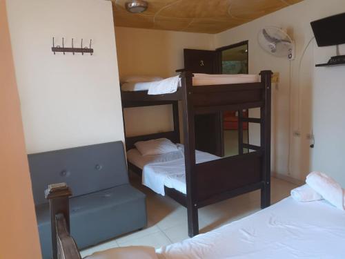 a room with three bunk beds and a mirror at Merkezi Saray in Villavieja