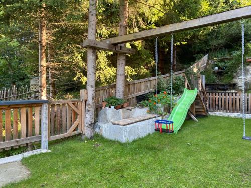 a backyard with a swing and a playground at Ferienwohnung Schiestl in Zell am Ziller