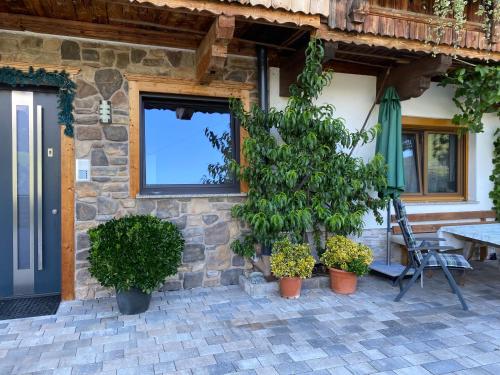a stone house with plants in front of it at Ferienwohnung Schiestl in Zell am Ziller