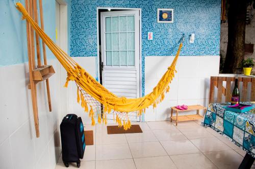 a room with a hammock in front of a door at Cantinho especial in Recife